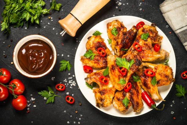 istock Grilled chicken wings at black. 1737739291
