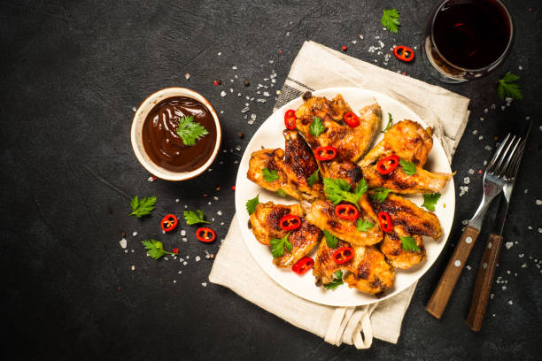 istock Grilled chicken wings at black. 1737741986