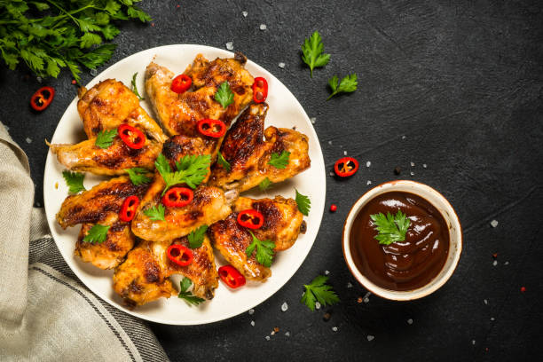 istock Grilled chicken wings at black. 1737742512