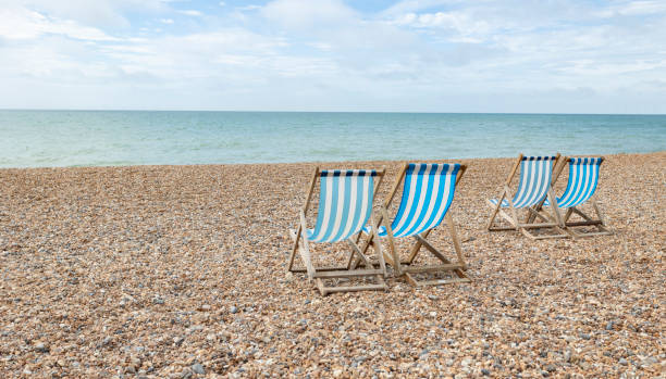 istock blue and white striped Deck Chairs on a Beach 1737742515