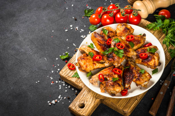 istock Grilled chicken wings at black. 1737742525