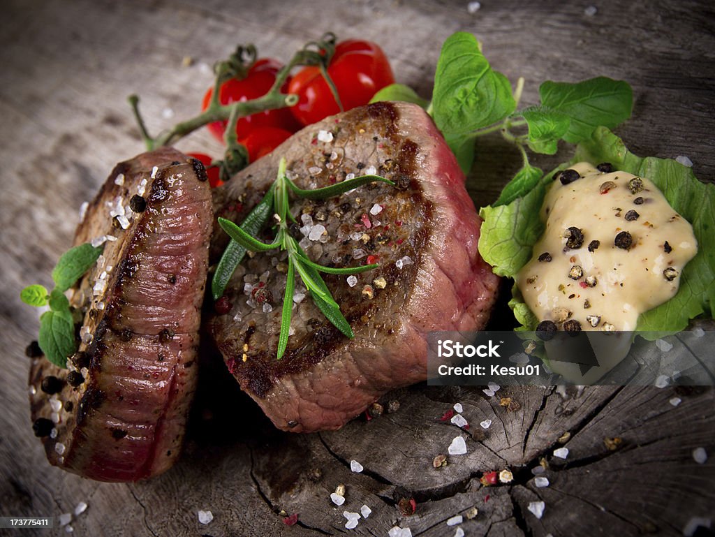 Delicious beef steak Delicious beef steak on wooden table Animal Blood Stock Photo