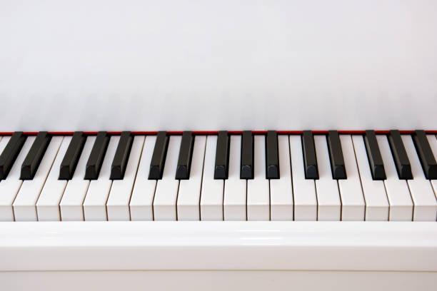 istock Black keys of a white piano. 1737760400