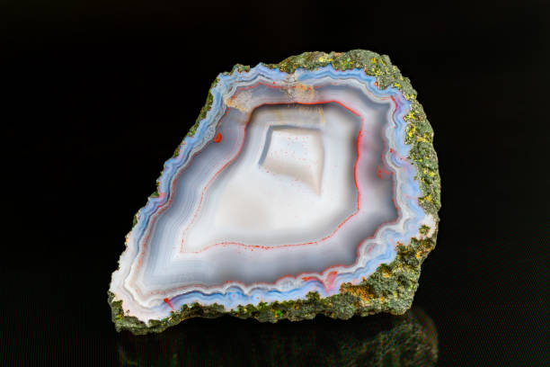 istock Beautiful natural agate mineral cross section with reflection on a black background 1737768233