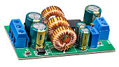 Electronic components on circuit board of power supply converter isolated on a white background