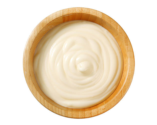 White creamy sauce in wooden bowl Studio shot of a bowl of creamy sauce cheese sauce stock pictures, royalty-free photos & images