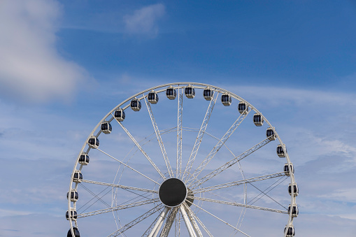 Dubai, UAE - March 04, 2021: Ferris wheel on Dubai Marina beach