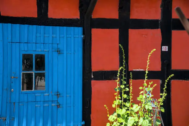 a traditional small,red,danish framehouse in summer in Bornholm with blue sky