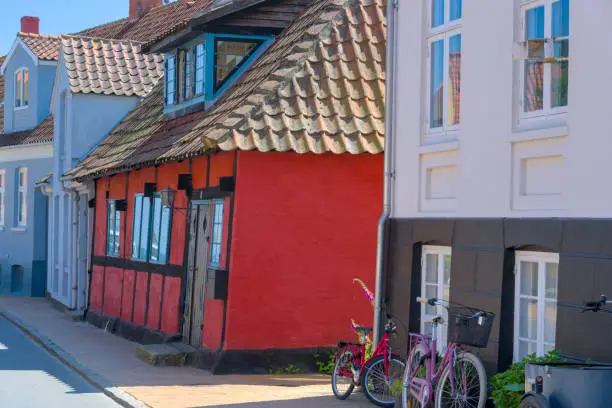a traditional small,red,danish framehouse in summer in Bornholm with blue sky