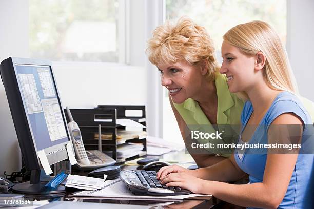 Woman And Girl In Home Office With Computer Smiling Stock Photo - Download Image Now