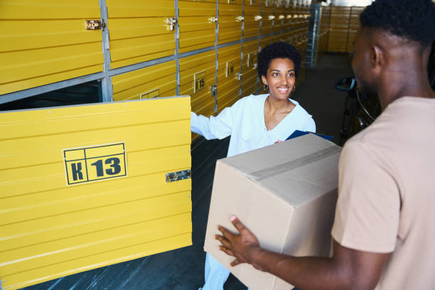 istock Beautiful woman manager opens cell for storing things for client 1737833154