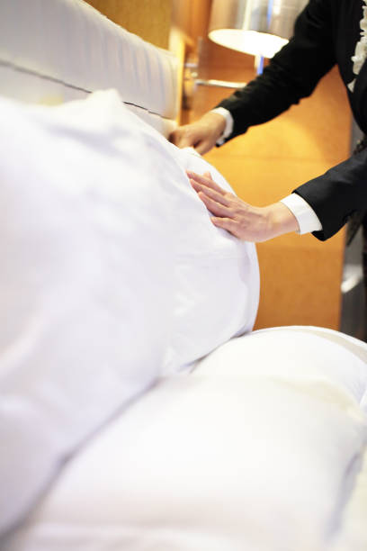 istock A person fluffing a big white pillow 173786173