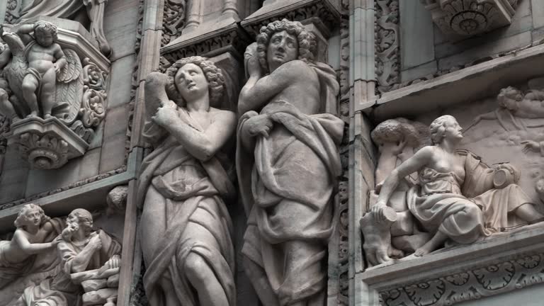 Gothic Sculptures and Statues Adorn the Exterior of the Historic Duomo Cathedral in Milan, Italy