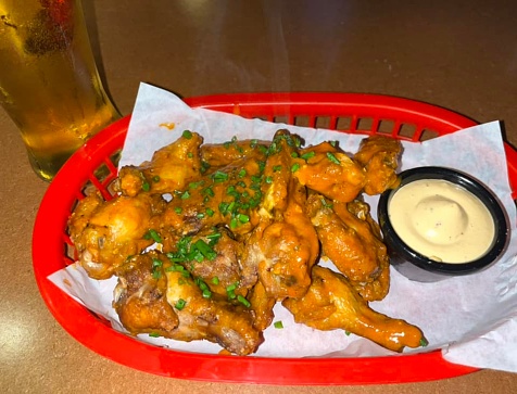 Buffalo wing in American cuisine is an unbreaded chicken wing section (flap or drumette) that is generally deep-fried, then coated or dipped in a sauce consisting of a vinegar-based cayenne pepper hot sauce and melted butter prior to serving