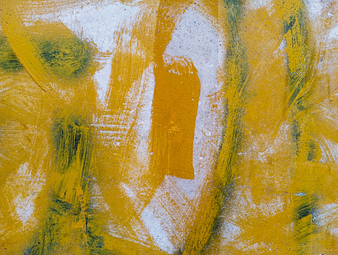 Painting on cement wall. Paint grungy cement wall.  Yellow paint texture.