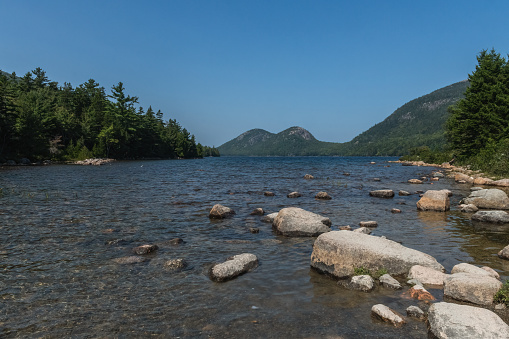 Jordan Pond from low level, with the Bubbles in the background and clear blue sky.