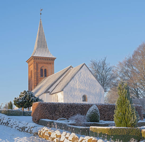 Snow covered Høje Taastrup Kirke Medieval village church at Christmas.