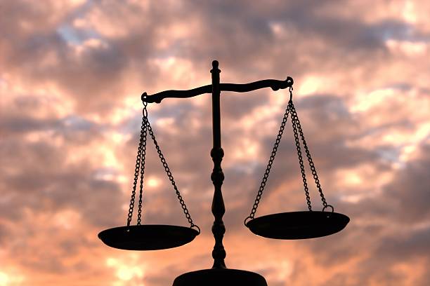 Balance Scale Against Multi-Colored Sky Silhouette of a balance scale taken against a dramatic sky. libra photos stock pictures, royalty-free photos & images