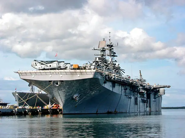 "Aircraft carrier docked at Pearl Harbor, Hawaii."