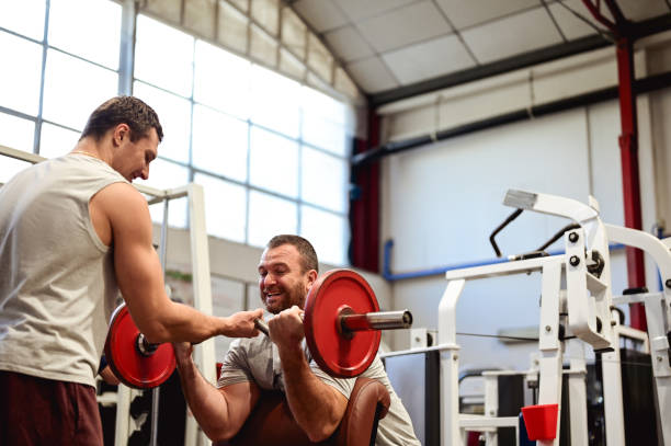 istock lifting barbells in a gym. 1737991260