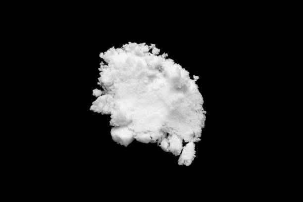 istock White snow isolated on black background close up 1738001284
