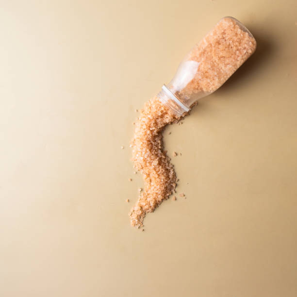 istock Bath sea salt pouring into the bottle . Home spa cocnept. 1738003737