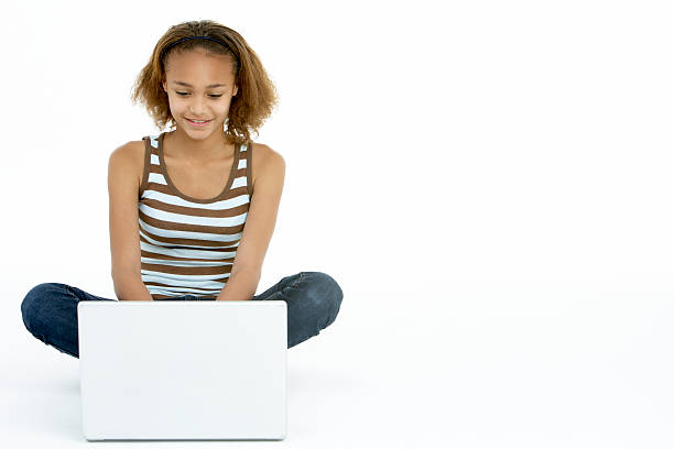 Teenage Girl Using Laptop stock photo