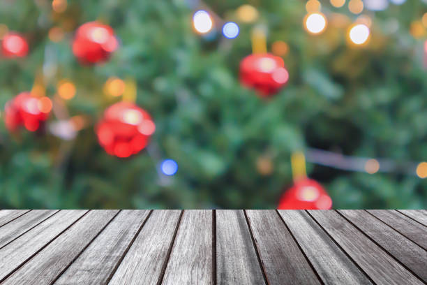 istock Empty wood table top with blur Christmas tree with bokeh light background 1738016222