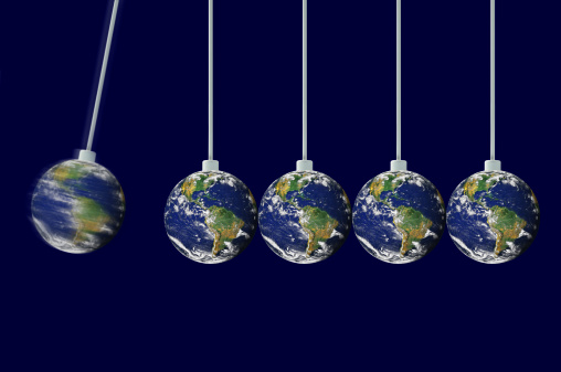 Newton's cradle with earths on a dark backgrounds Earth image: http://www.visibleearth.nasa.gov