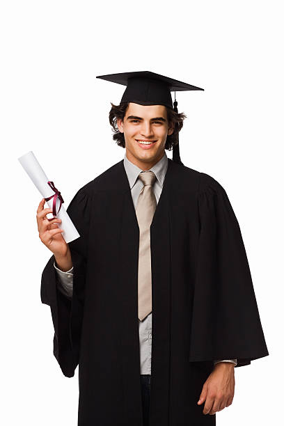 istock Boy in graduation robes holding a diploma 173803096