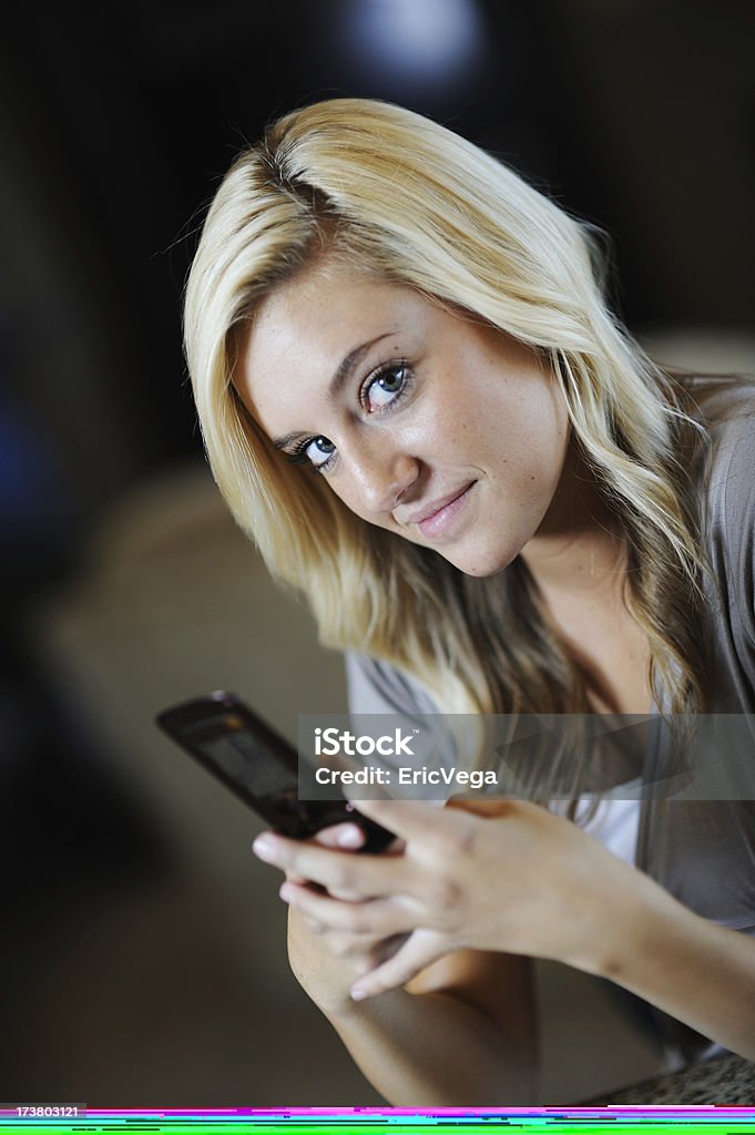 Shocking Text Message Woman shocked reading her text message 16-17 Years Stock Photo