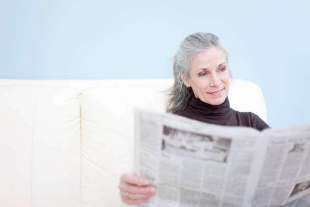 belle senoir femme lisant le journal - book reading white women photos et images de collection