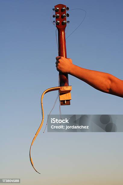 Extended Arm Holding A Busted Guitar Stock Photo - Download Image Now - Broken, Guitar, Acoustic Guitar