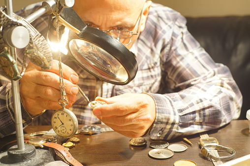 Close-up view of watchmaker repairing a wristwatch.