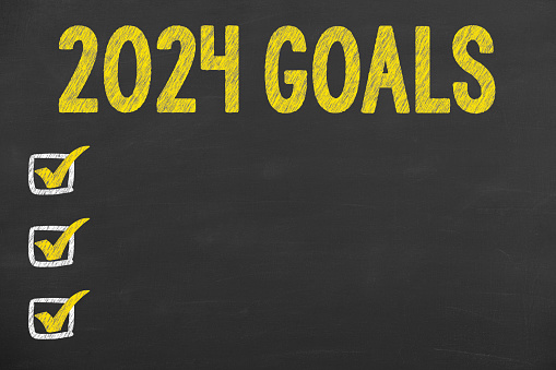 New Year 2024 Goals on Chalkboard Background