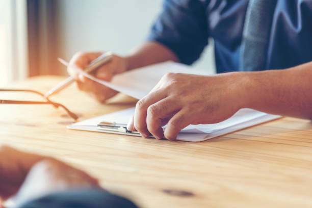 istock Businessman hands note meeting document in conference room. man Hands writing planning notebook. Close up male hand holding pencil write on diary sketchbook at office desk. Business Planning Concept 1738081076