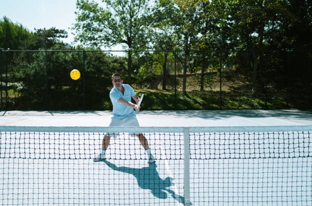 istock Adults Playing Pickleball on a Public Court 1738084897