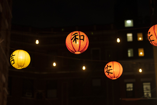 Hanging lanterns glow over Doyers Street in Chinatown, NYC