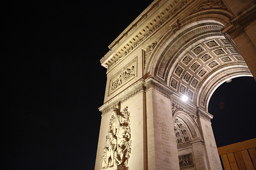 Night view at neoclassical monument - Triumphal Arch in Paris, France