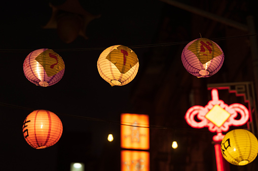 Hanging lanterns glow over Doyers Street in Chinatown, NYC