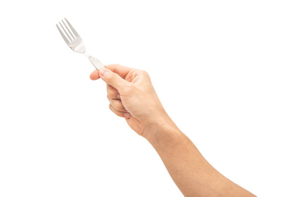 istock isolated of a man's hand holding a silver steel fork. 1738115274