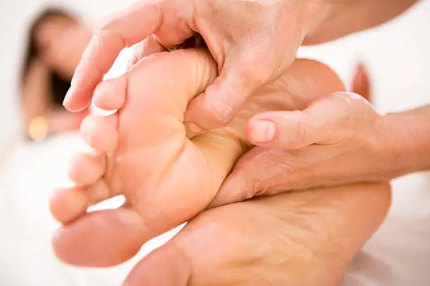 "Woman receiving foot massage, canon 1Ds mark III"