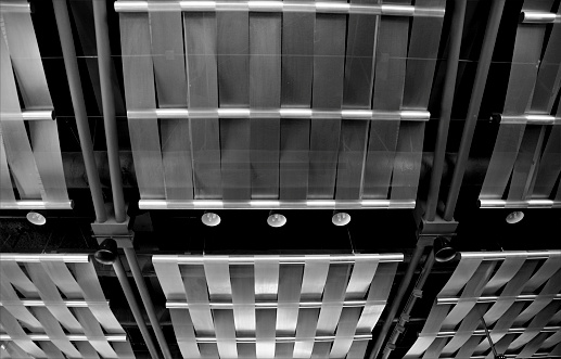 The abstract architectural detail of a ceiling in an office conference room.