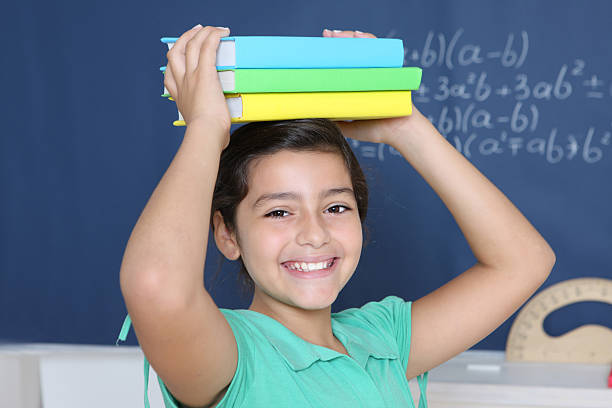 istock smiling girl with textbooks 173812330