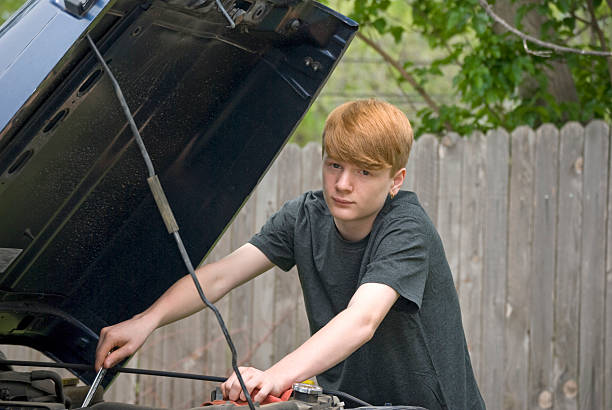 istock Teenage Boy Working on a Car 173812922