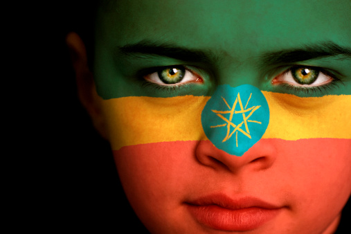 Portrait of a boy with the flag of Ethiopia painted on his face