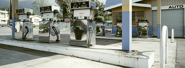 Gas Station An out of business gas station from the 1970s. The photo is taken with a panoramic camera (Hasselbad XPAN), 45mm lens. energy crisis photos stock pictures, royalty-free photos & images
