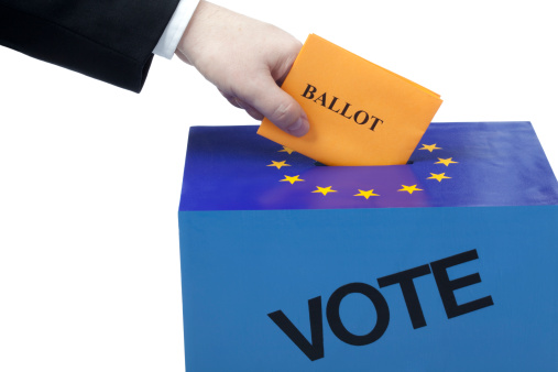 Male hand inserting a ballot to a voting box. Isolated on white. European Union flag.