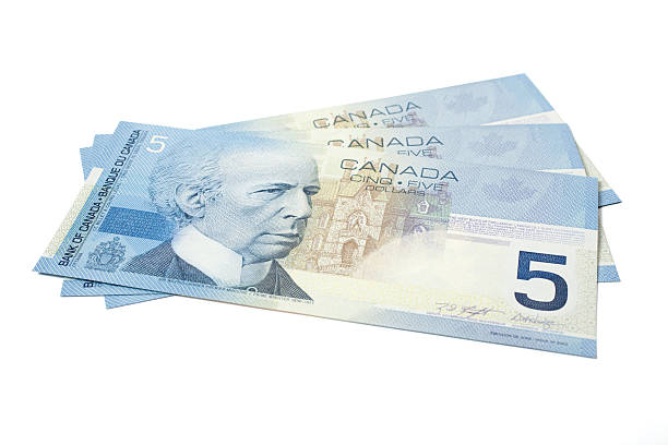 Five Dollar Bills Three five dollar bill in Canadian currency on a white background. wilfrid laurier stock pictures, royalty-free photos & images