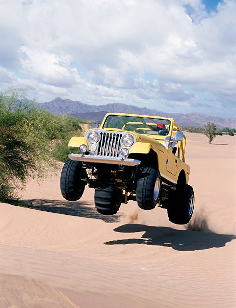 Jumping Yellow Jeep stock photo